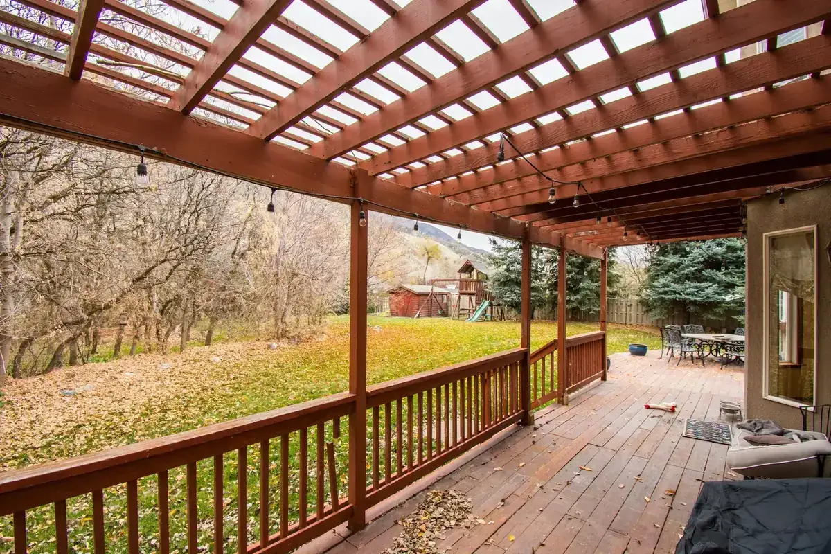 A beautiful wooden deck with autumn leaves, perfect for relaxing outdoors