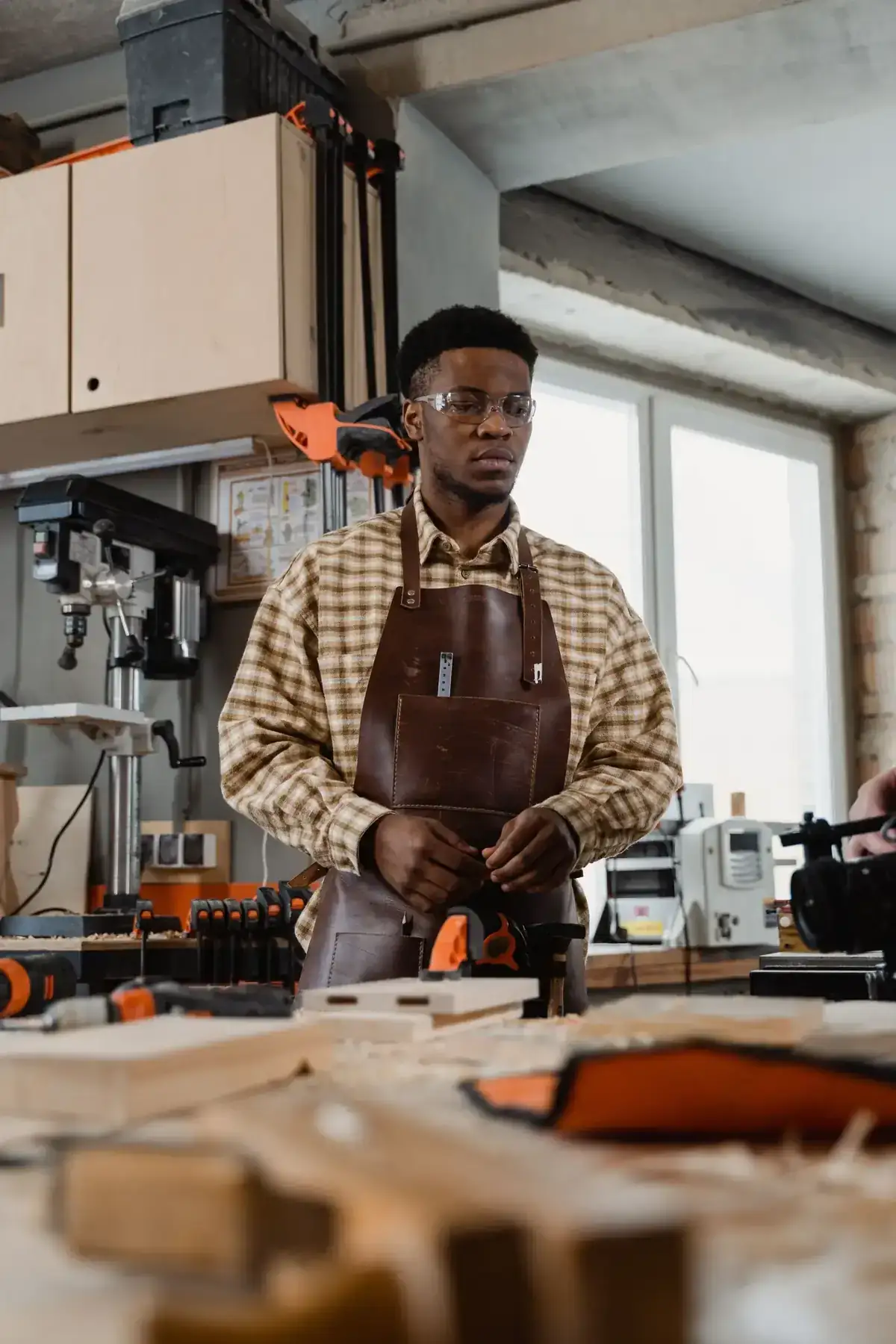 A skilled carpenter in his workshop surrounded by tools and materials