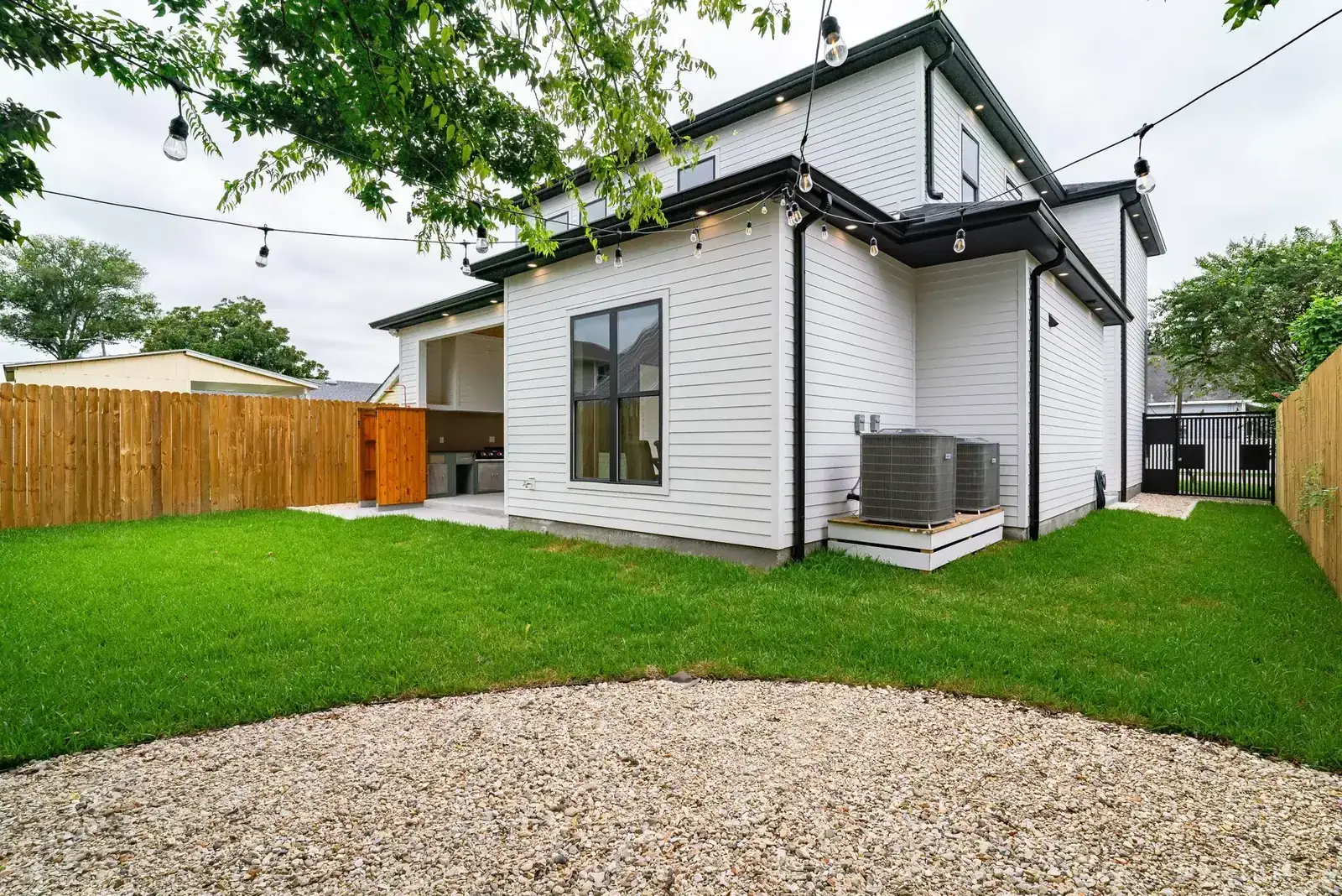 Spacious backyard view featuring a modern exterior and neat landscaping