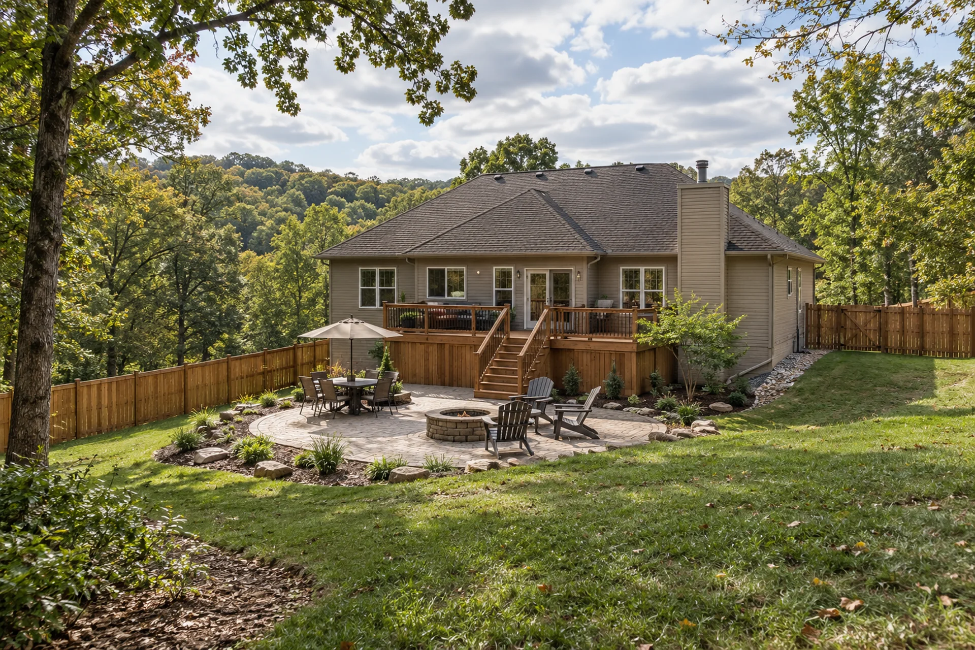Connected fence, deck, patio, and landscape on a wooded Mid-Missouri property