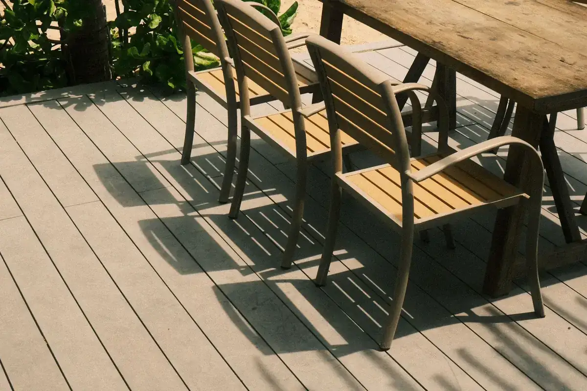 Outdoor chairs and table arranged on a sunny residential deck