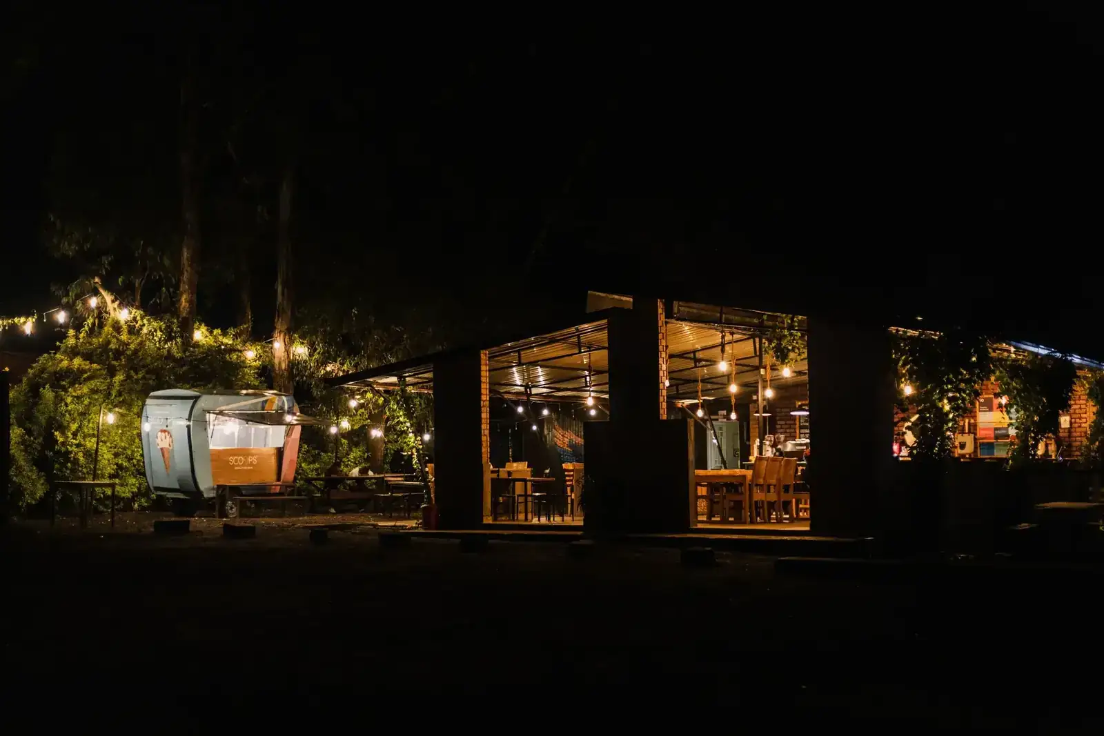 Timber outdoor terrace illuminated by warm string lights at night