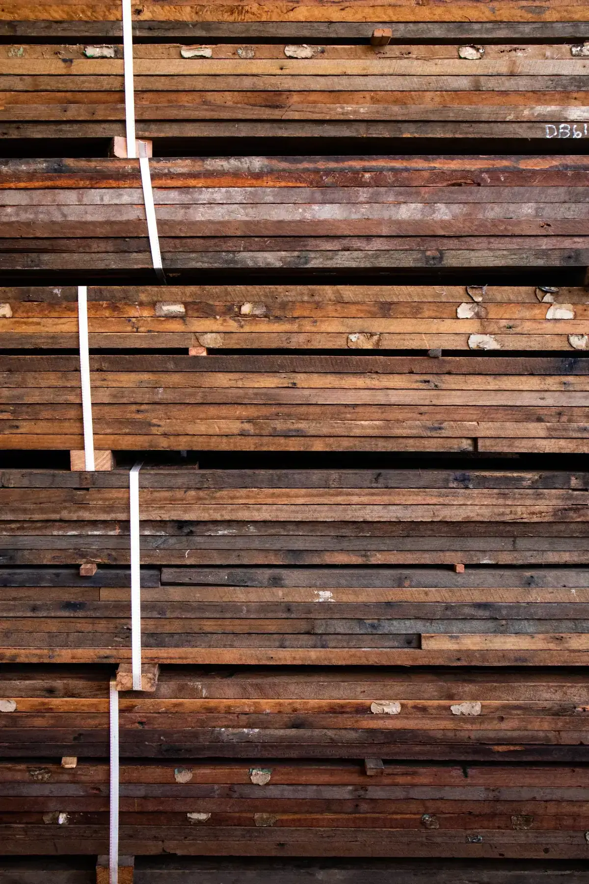 Close-up of stacked wooden planks bound for storage or transport, showing texture