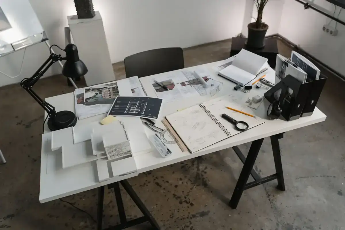 A creative workspace with architectural tools, blueprints, and sketches for design projects