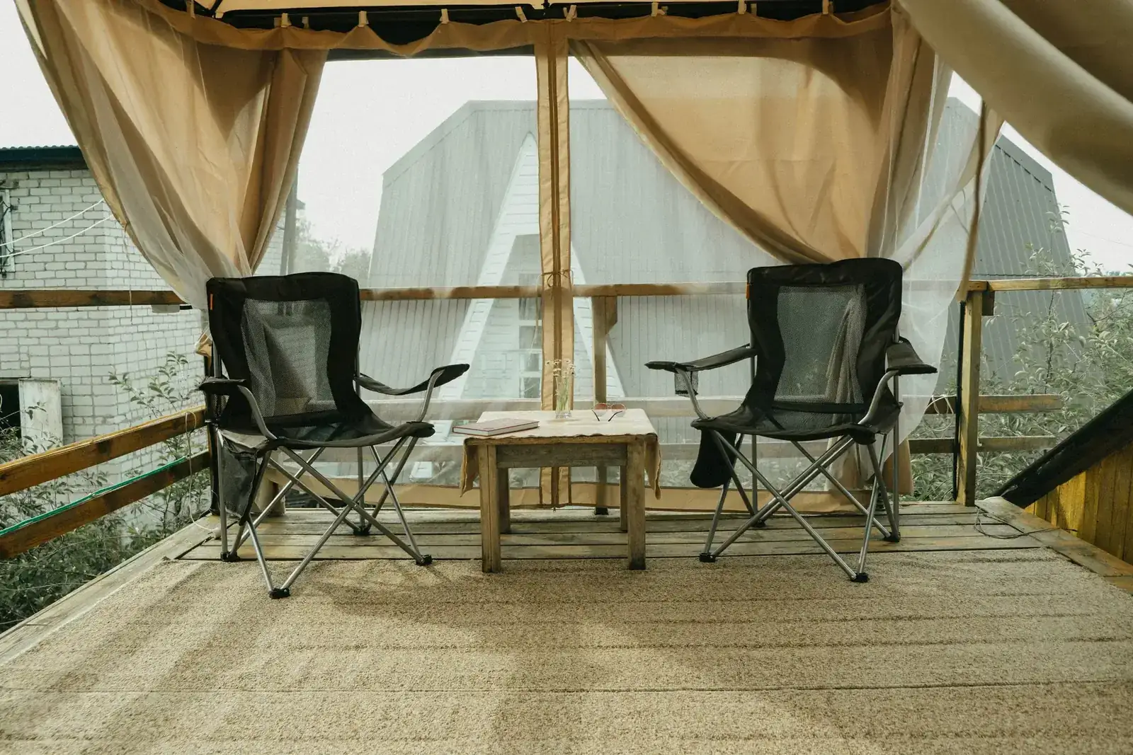 Inviting patio deck with folding chairs and wooden table, ideal for relaxing outdoors