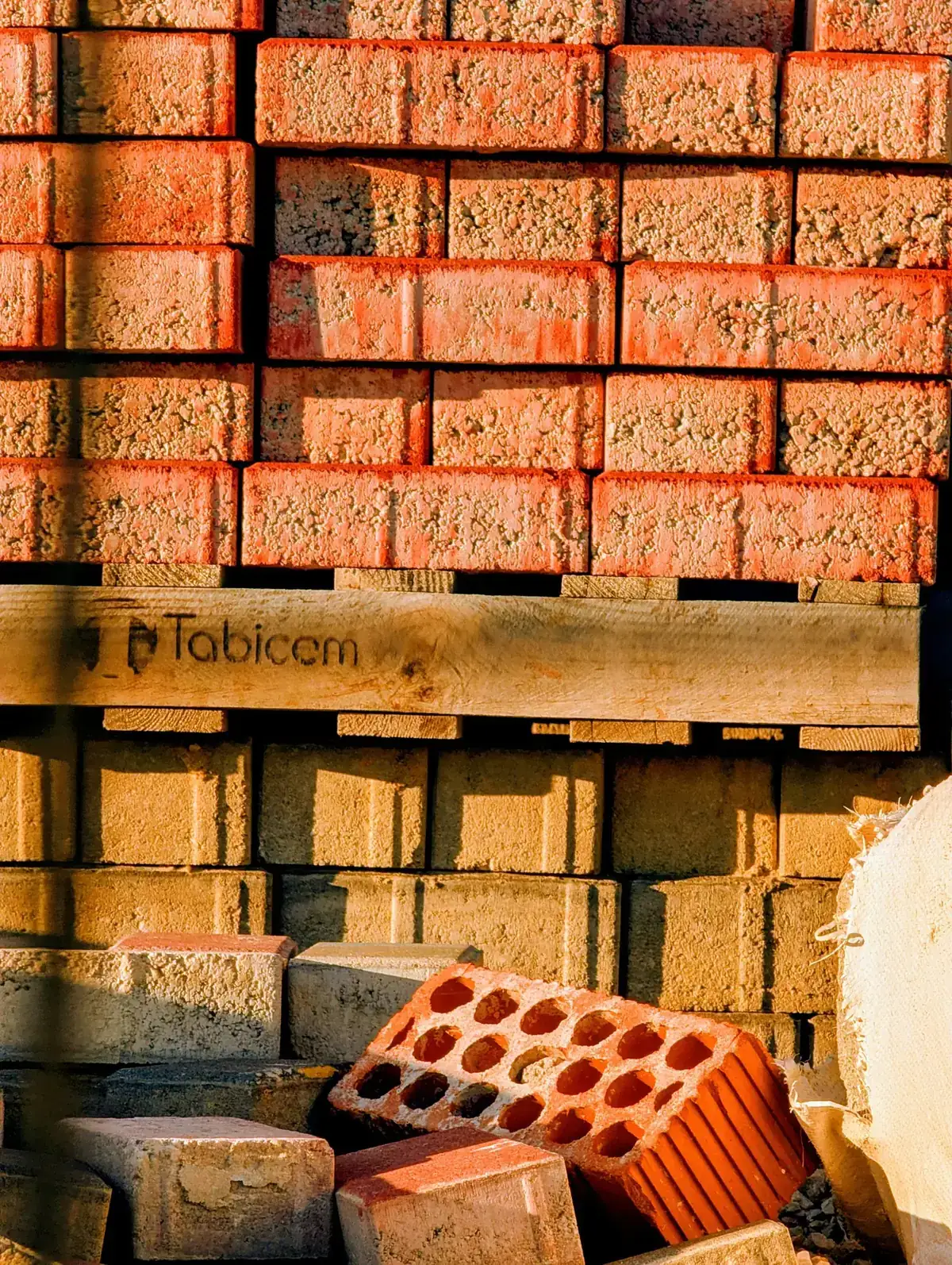 Neatly stacked red bricks at an outdoor construction site highlighting building materials