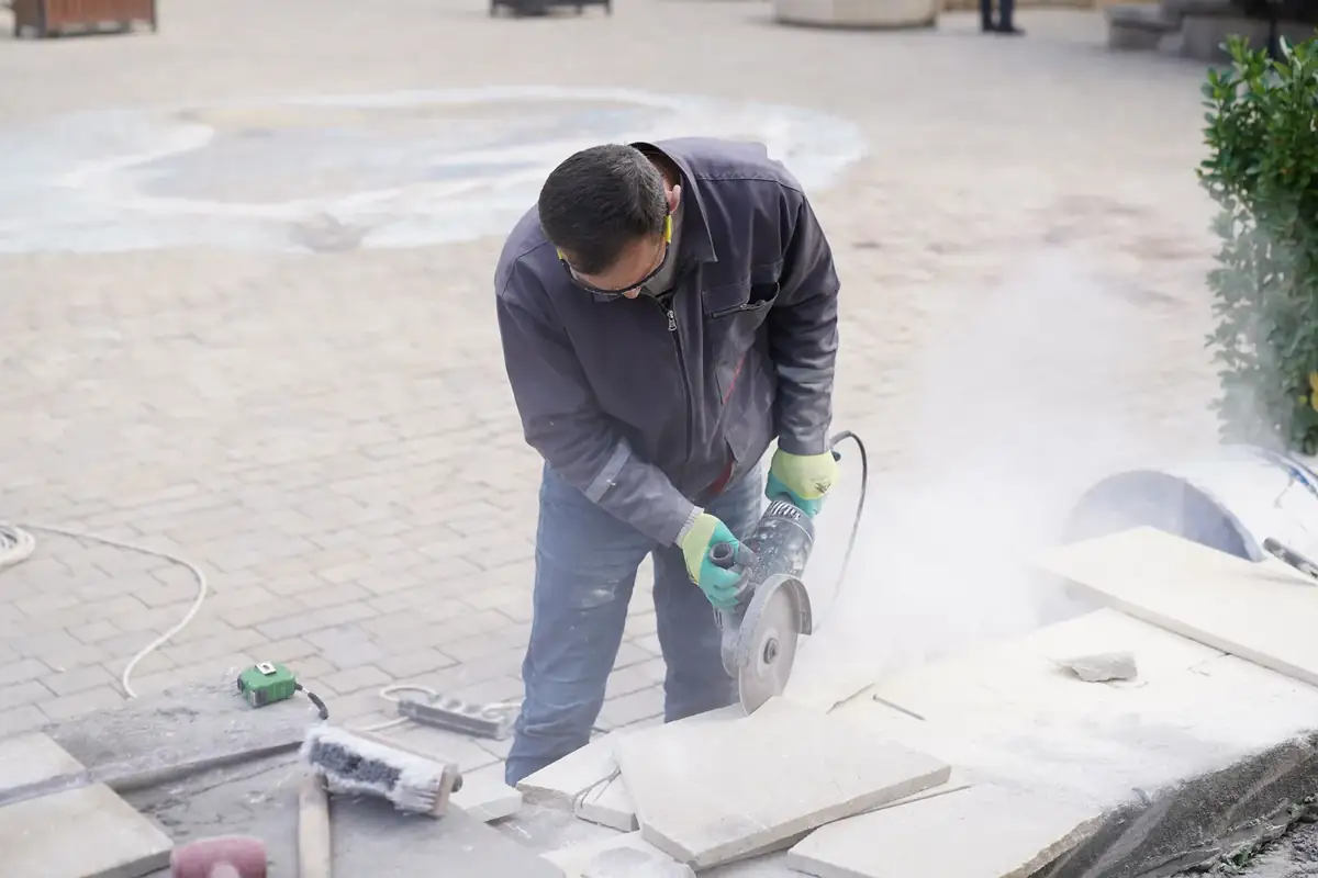 Installer cutting stone pavers for a residential patio