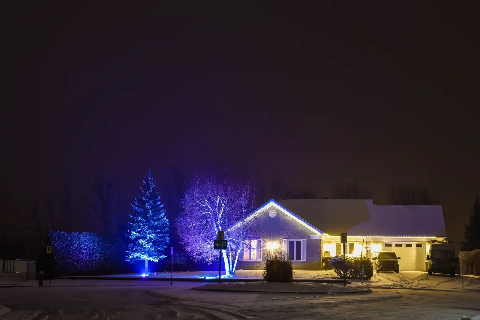 Midwestern home and landscape lighting glowing on a winter night